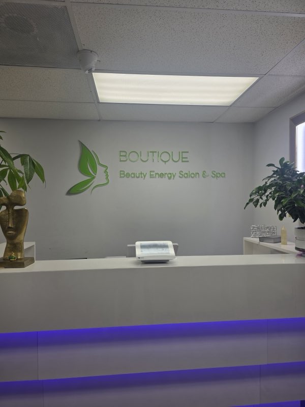 Reception desk with the Beauty Energy Salon & Spa butterfly logo