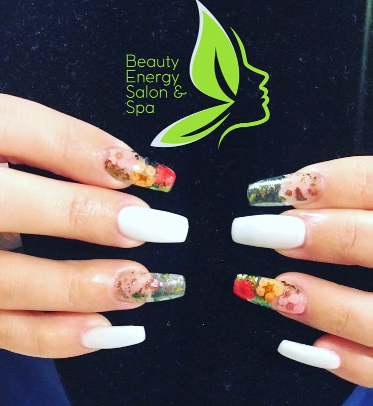 White coffin nails with dried-flower art at Beauty Energy Salon & Spa